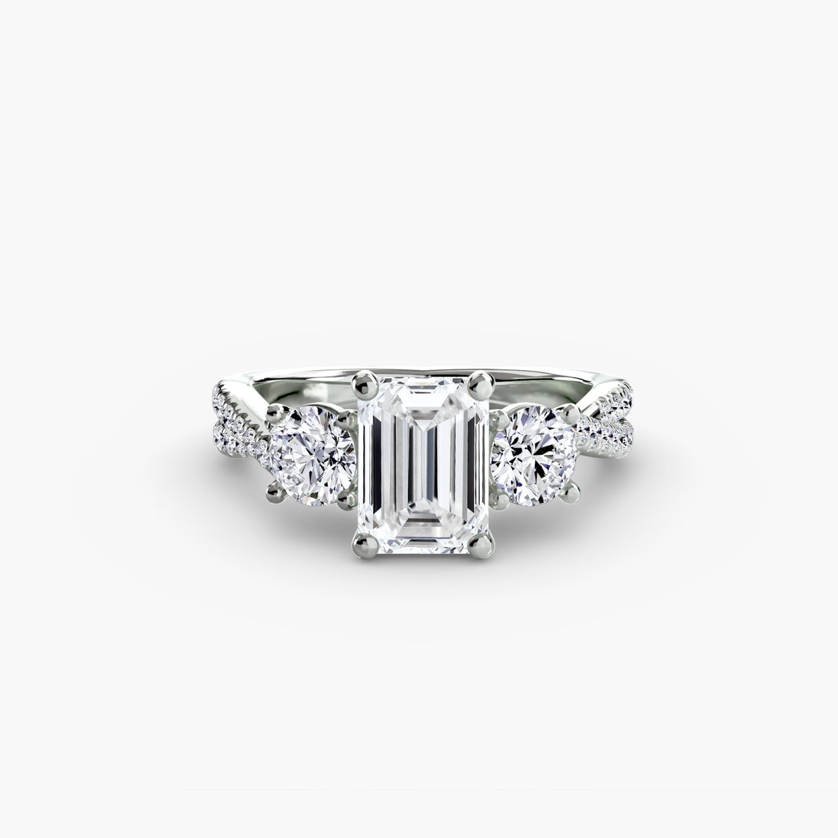 Three-Stone with Pavé Band engagement ring in white gold with an emerald-cut centre stone