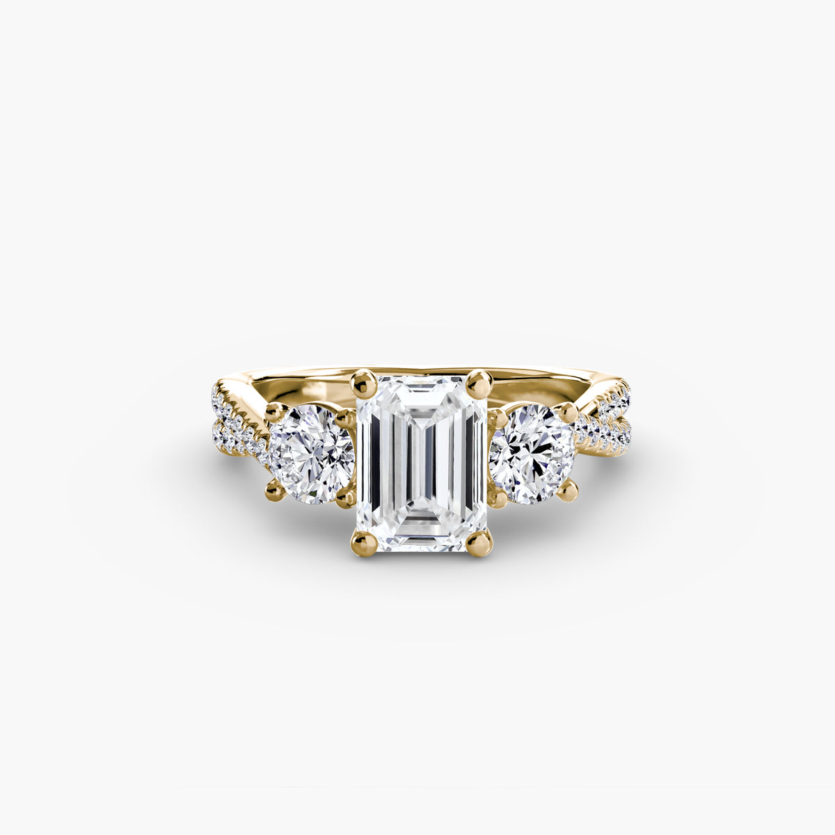 Three-Stone with Pavé Band engagement ring in yellow gold with an emerald-cut centre stone