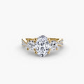 Three-Stone with Pavé Band engagement ring in yellow gold with an oval centre stone