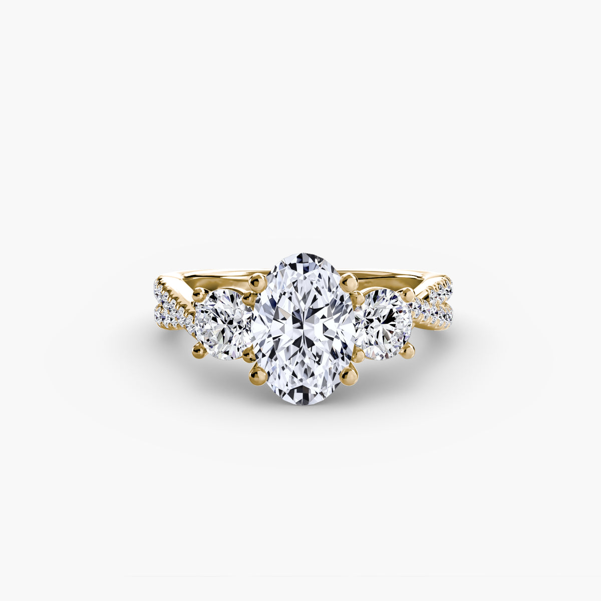 Three-Stone with Pavé Band engagement ring in yellow gold with an oval centre stone