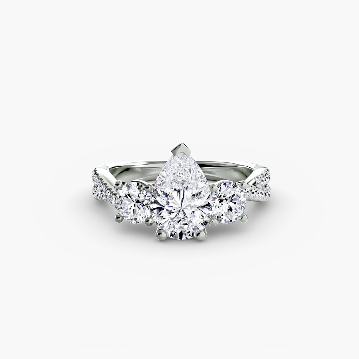 Three-Stone with Pavé Band engagement ring in white gold with a pear-shaped centre stone