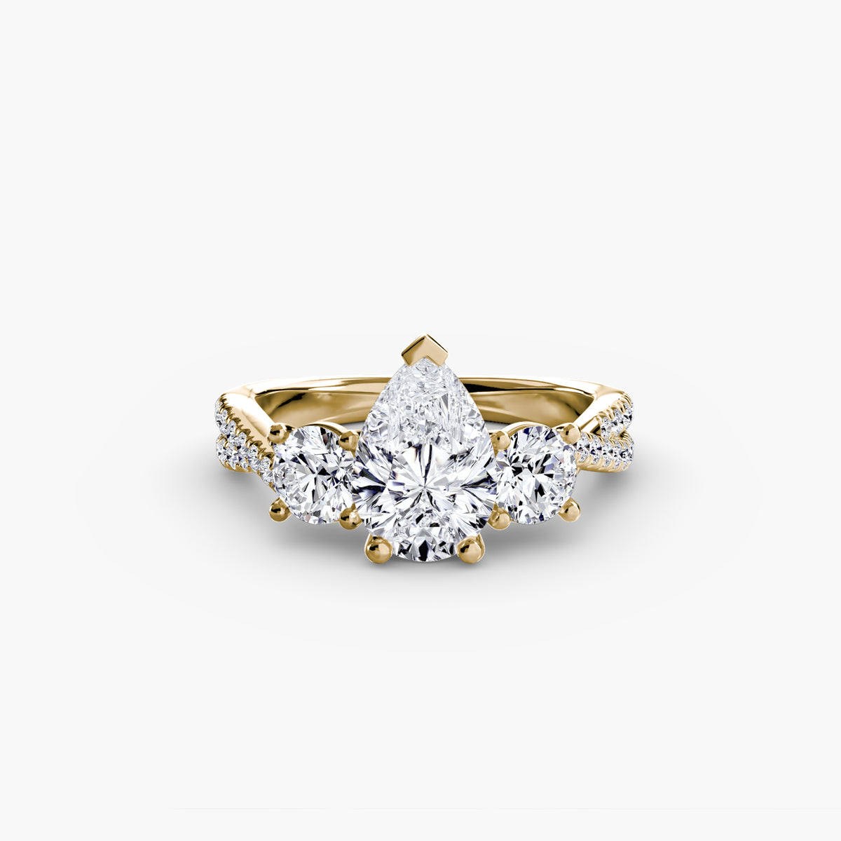 Three-Stone with Pavé Band engagement ring in yellow gold with a pear-shaped centre stone