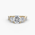 Three-Stone with Pavé Band engagement ring in yellow gold with a round centre stone