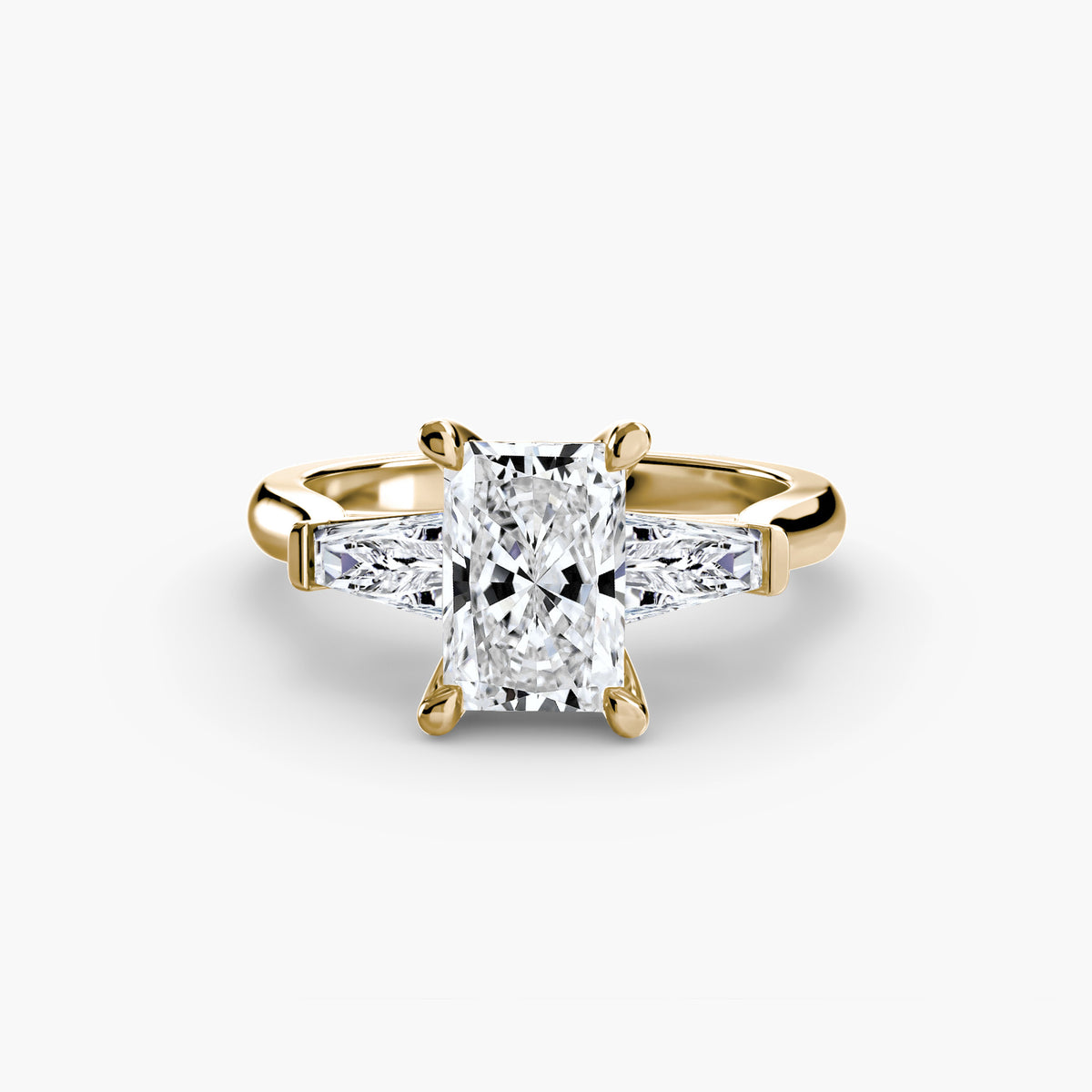 Three-Stone Ring (Baguette Side Stones) in yellow gold with a radiant-cut centre stone
