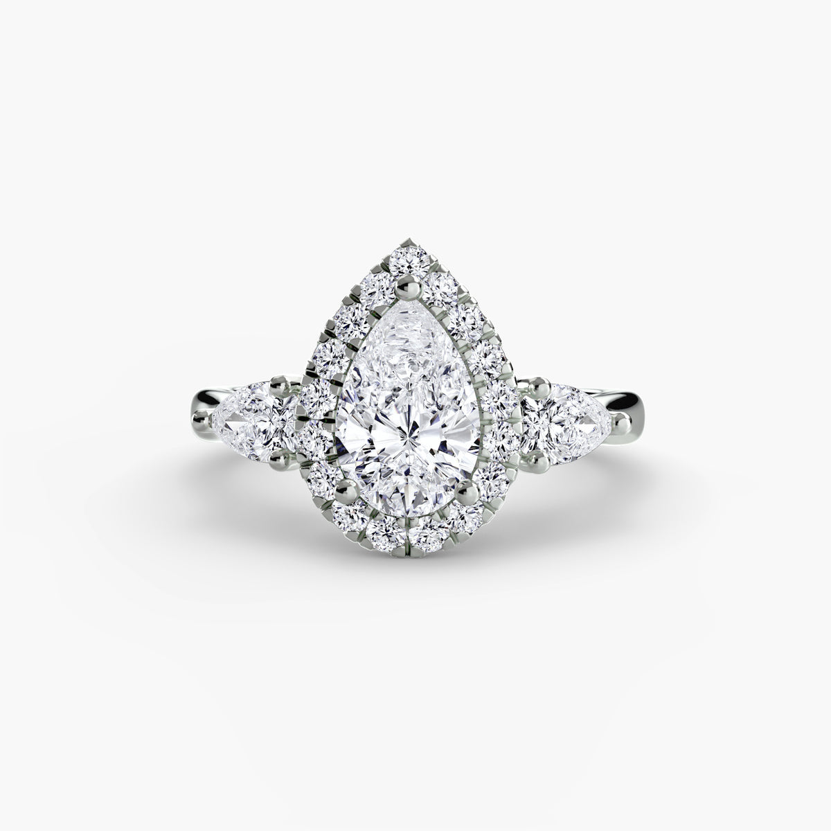 Three-Stone Ring with Halo in white gold with a pear-shaped centre stone