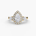 Three-Stone Ring with Halo in yellow gold with a pear-shaped centre stone