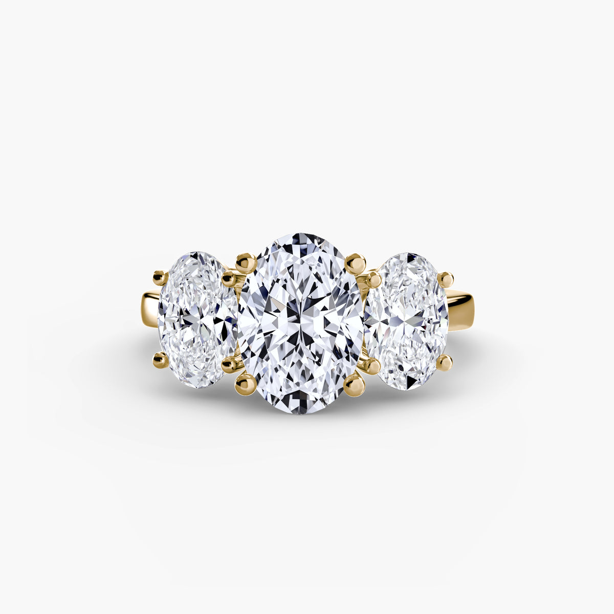 Trilogy Oval engagement ring in yellow gold with an oval centre stone