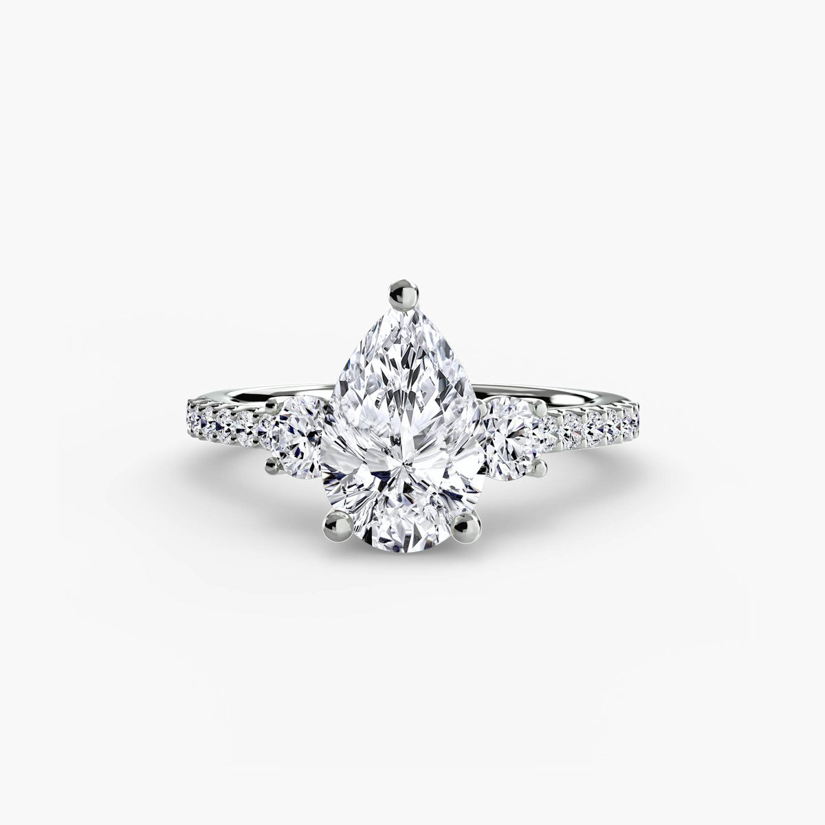 Three-Stone Ring with Pavé Band in white gold with a pear-shaped centre stone