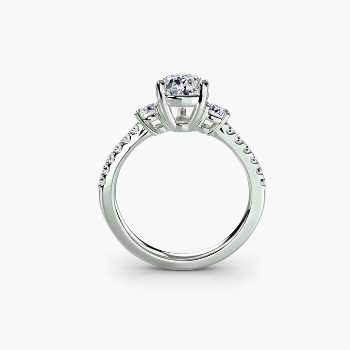 Three-Stone Ring with Pavé Band in white gold with a pear-shaped centre stone, front view