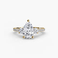 Three-Stone Ring with Pavé Band in yellow gold with a pear-shaped centre stone