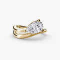 The Wave Ring in yellow gold with a pear-shaped centre stone