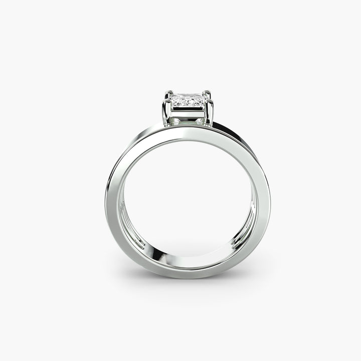 Wide Band Solitaire engagement ring in white gold with an emerald-cut centre stone, front view
