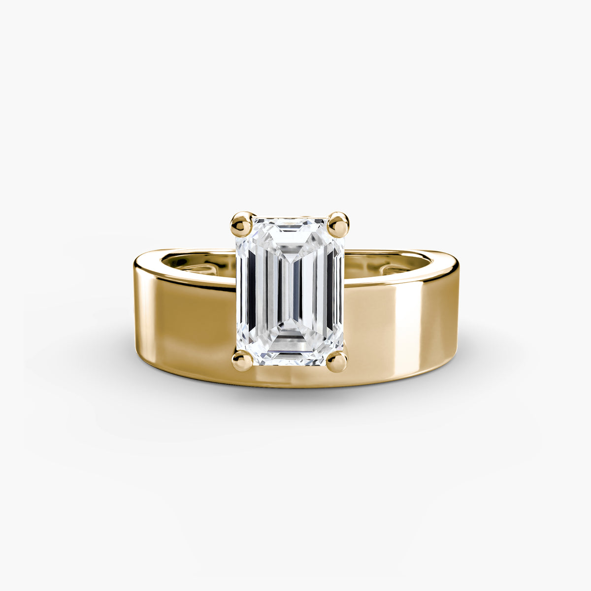 Wide Band Solitaire engagement ring in yellow gold with an emerald-cut centre stone