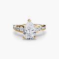 Solitaire with Pavé engagement ring in yellow gold with a pear-shaped centre stone