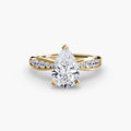 Solitaire with Pavé engagement ring in yellow gold with a pear-shaped centre stone