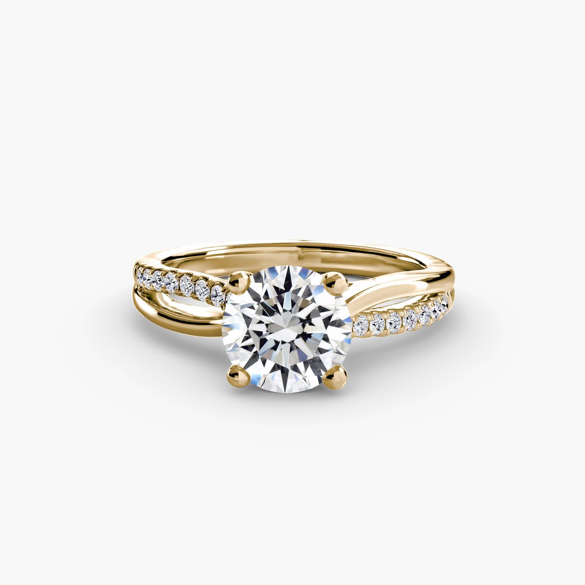 The Split Shank Pavé Solitaire engagement ring in yellow gold with a round centre stone