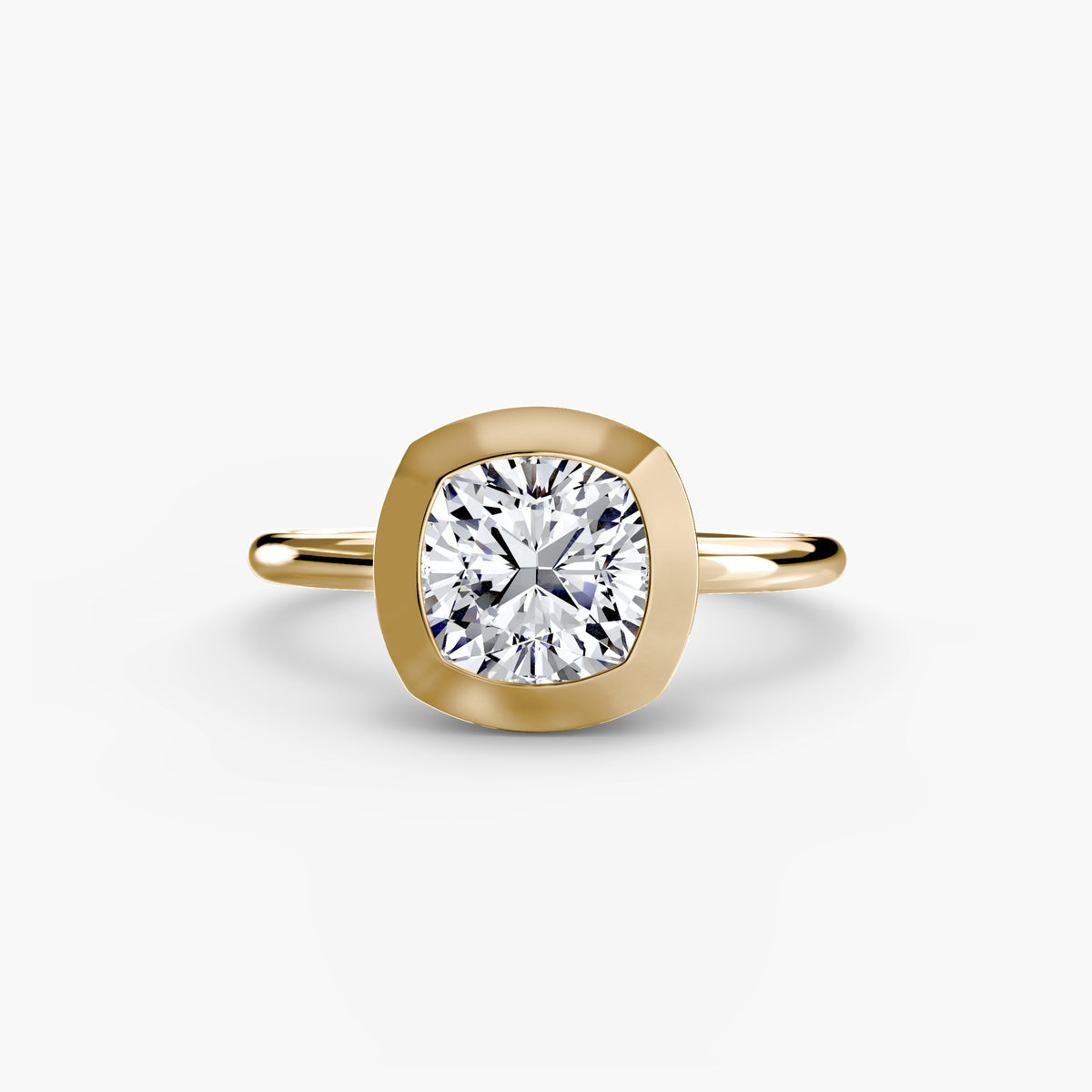 The Bezel Set Solitaire engagement ring in yellow gold with a cushion-cut centre stone