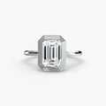 The Bezel Set Solitaire engagement ring in white gold with an emerald-cut centre stone
