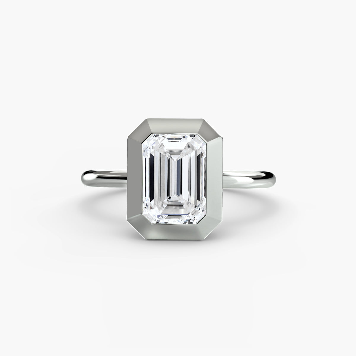 The Bezel Set Solitaire engagement ring in white gold with an emerald-cut centre stone