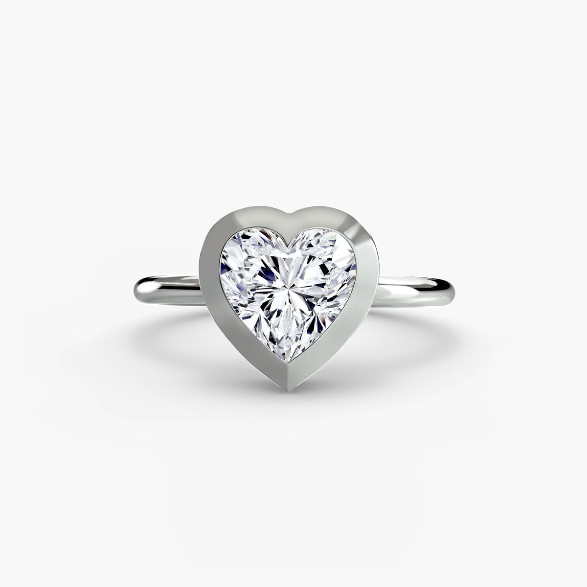 The Bezel Set Solitaire engagement ring in white gold with a heart-shaped centre stone