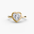 The Bezel Set Solitaire engagement ring in yellow gold with a heart-shaped centre stone
