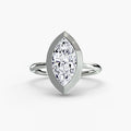 The Bezel Set Solitaire engagement ring in white gold with a marquise centre stone