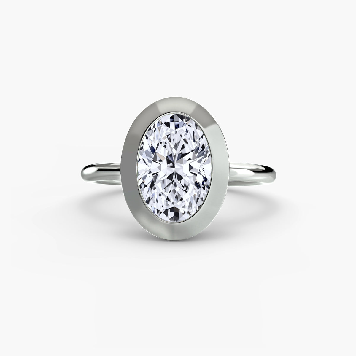 The Bezel Set Solitaire engagement ring in white gold with an oval centre stone