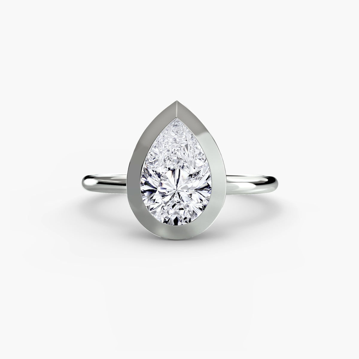 The Bezel Set Solitaire engagement ring in white gold with a pear-shaped centre stone