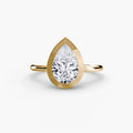 The Bezel Set Solitaire engagement ring in yellow gold with a pear-shaped centre stone
