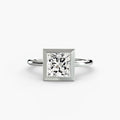 The Bezel Set Solitaire engagement ring in white gold with a princess-cut centre stone