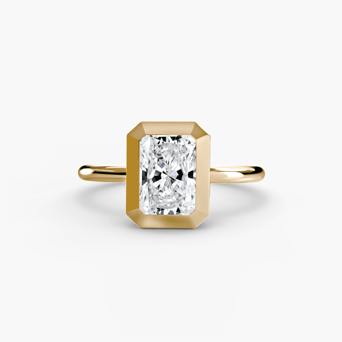 The Bezel Set Solitaire engagement ring in yellow gold with a radiant-cut centre stone