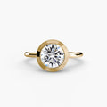 The Bezel Set Solitaire engagement ring in yellow gold with a round centre stone
