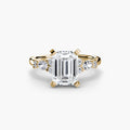 The Floral Accent Solitaire engagement ring in yellow gold with an emerald-cut centre stone