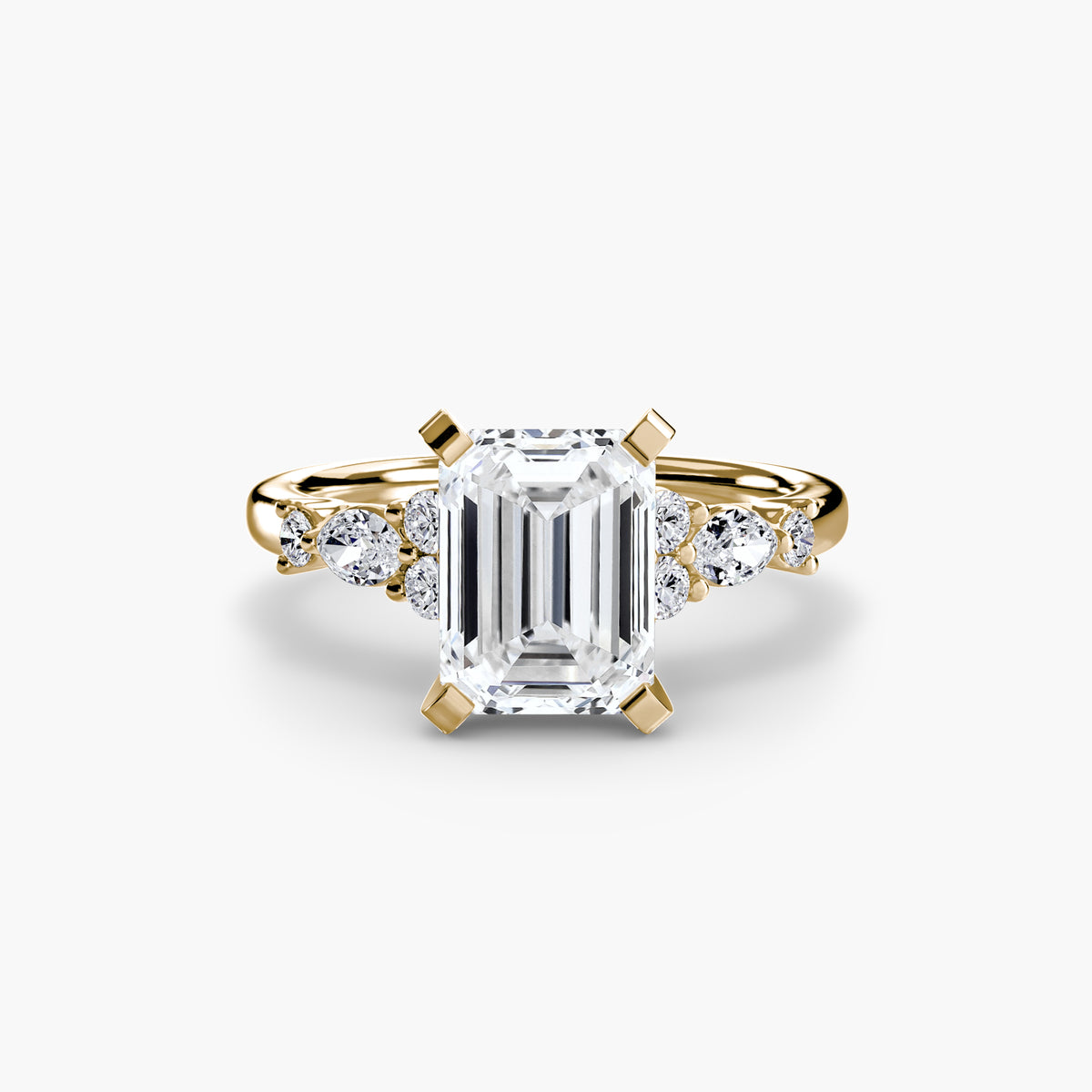 The Floral Accent Solitaire engagement ring in yellow gold with an emerald-cut centre stone