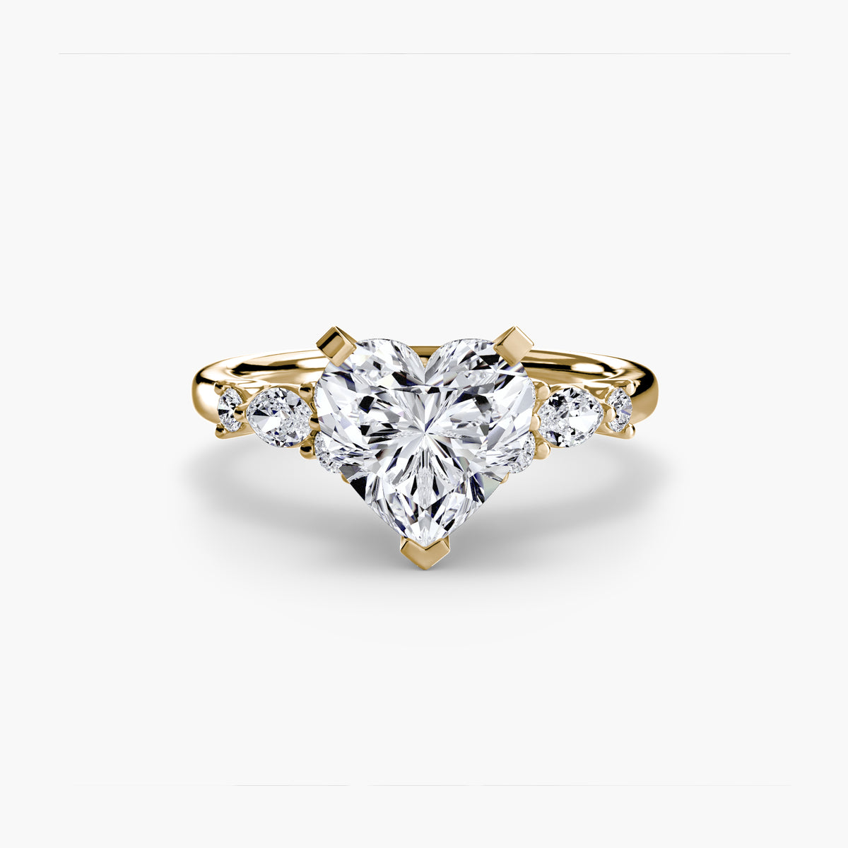 The Floral Accent Solitaire engagement ring in yellow gold with a heart-shaped centre stone