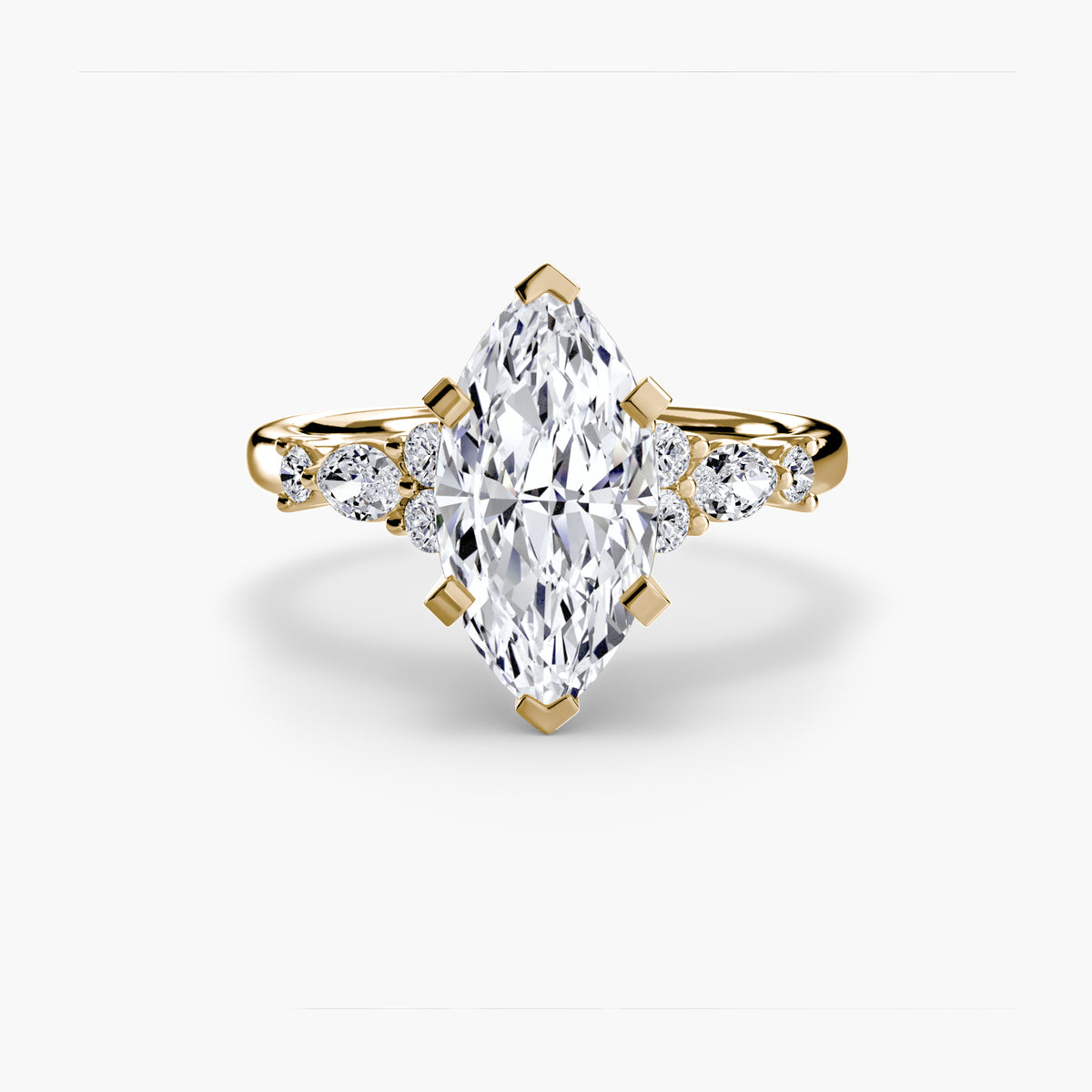 The Floral Accent Solitaire engagement ring in yellow gold with a marquise centre stone