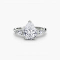 The Floral Accent Solitaire engagement ring in white gold with a pear-shaped centre stone