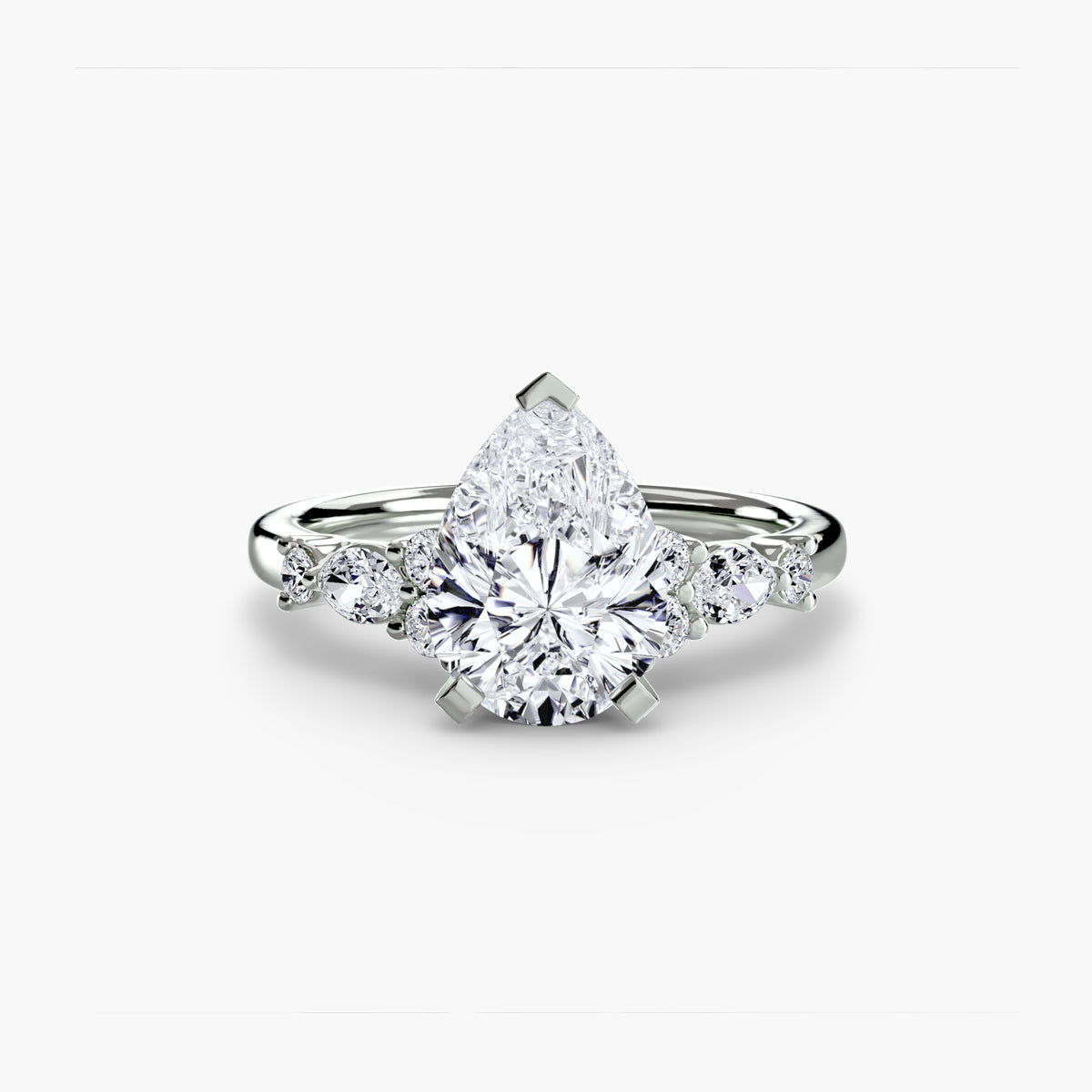 The Floral Accent Solitaire engagement ring in white gold with a pear-shaped centre stone