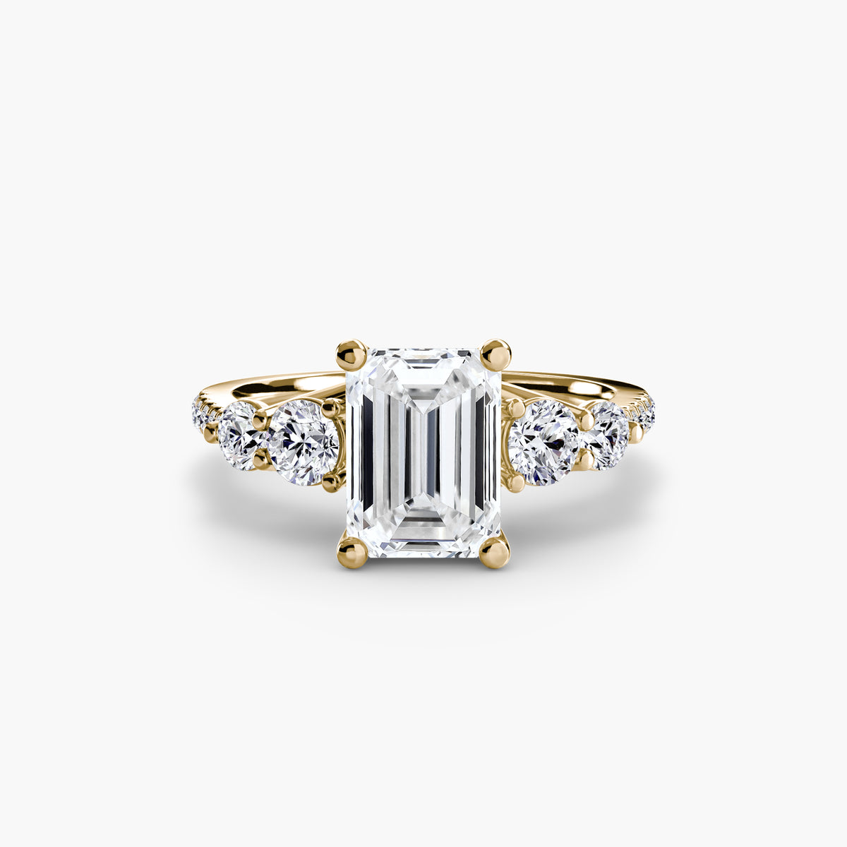 Five Stone Ring with Pavé Band in yellow gold with an emerald-cut centre stone