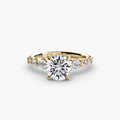 The Cascade Diamond Ring in yellow gold with a round centre stone
