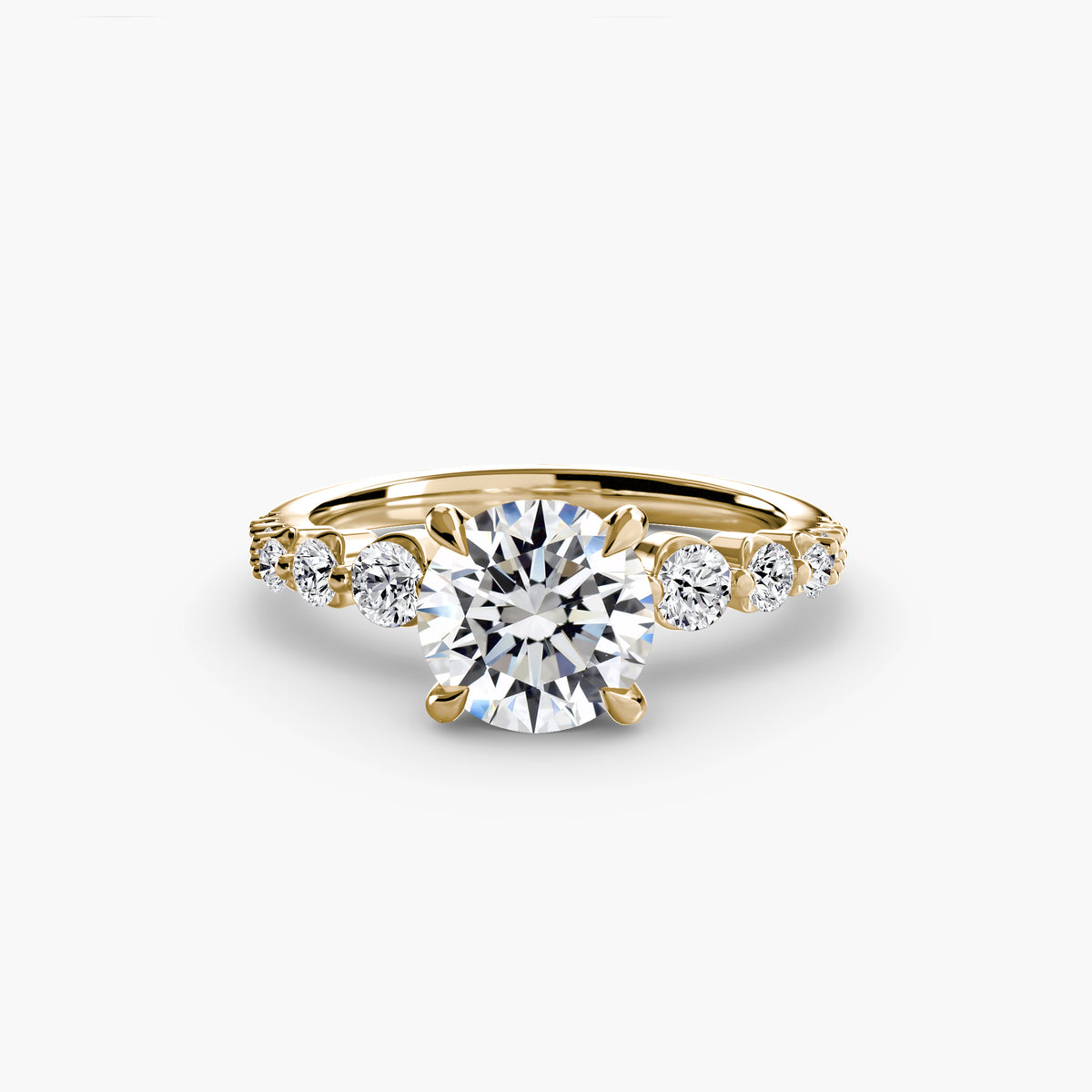 The Cascade Diamond Ring in yellow gold with a round centre stone