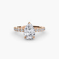 Solitaire with Pavé engagement ring in rose gold with a pear-shaped centre stone
