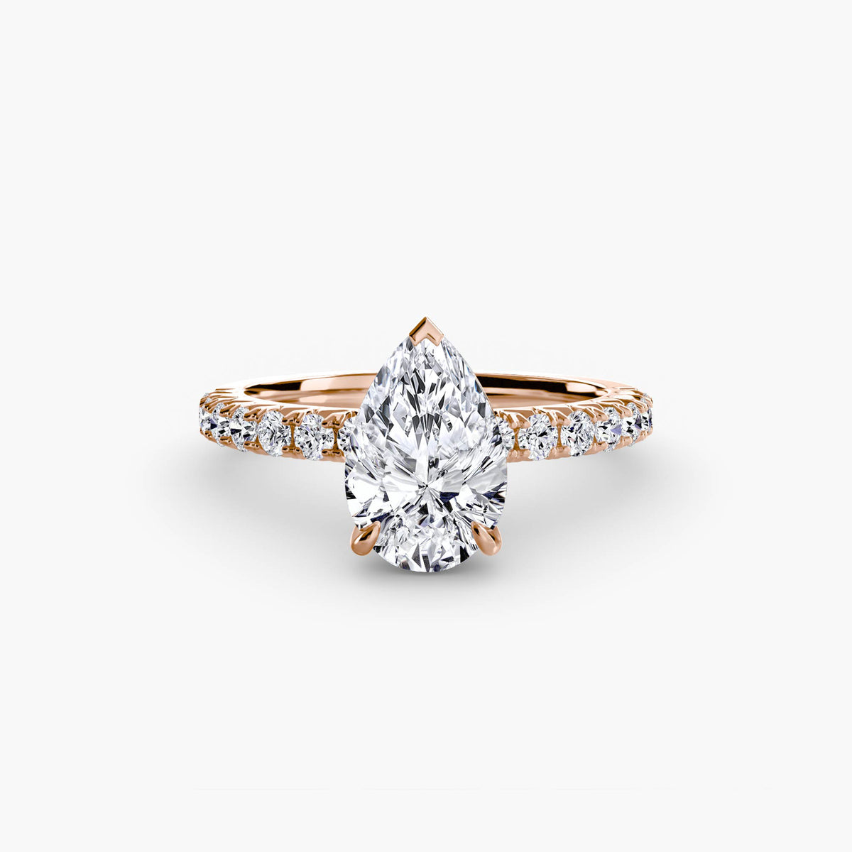 Solitaire with Pavé engagement ring in rose gold with a pear-shaped centre stone