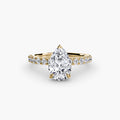 Solitaire with Pavé engagement ring in yellow gold with a pear-shaped centre stone