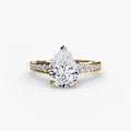 Solitaire with Pavé engagement ring in yellow gold with a pear-shaped centre stone