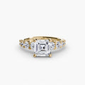 The Graduated Accent Ring in yellow gold with an Asscher-cut centre stone