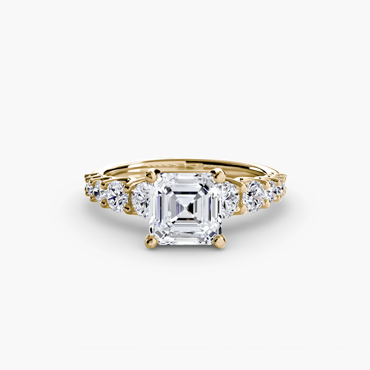 The Graduated Accent Ring in yellow gold with an Asscher-cut centre stone