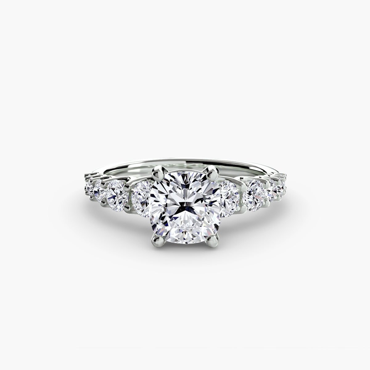 The Graduated Accent Ring in white gold with a cushion-cut centre stone