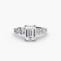 The Graduated Accent Ring in white gold with an emerald-cut centre stone