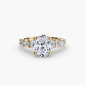 The Graduated Accent Ring in yellow gold with an oval centre stone